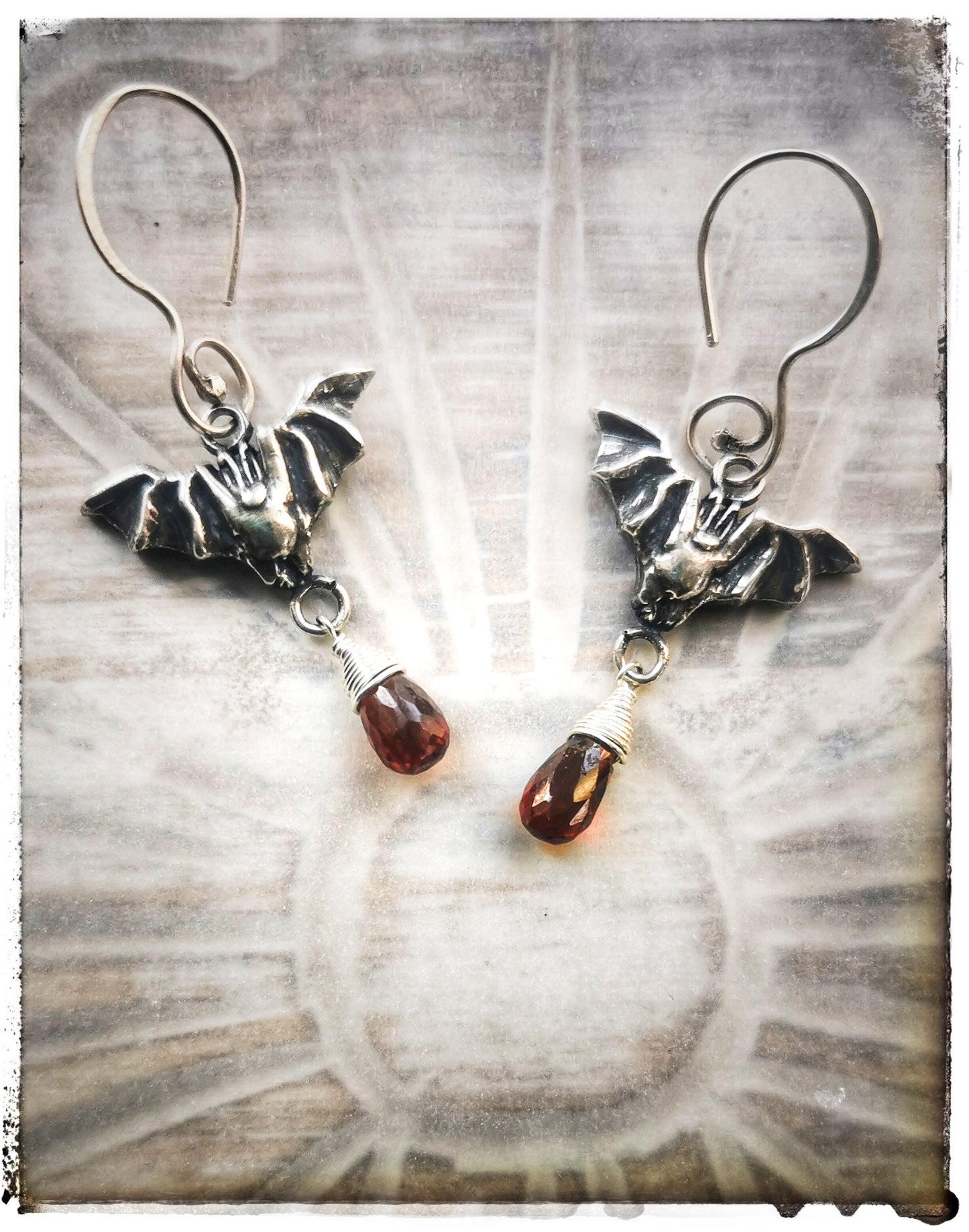 Bat earrings with Garnet drops