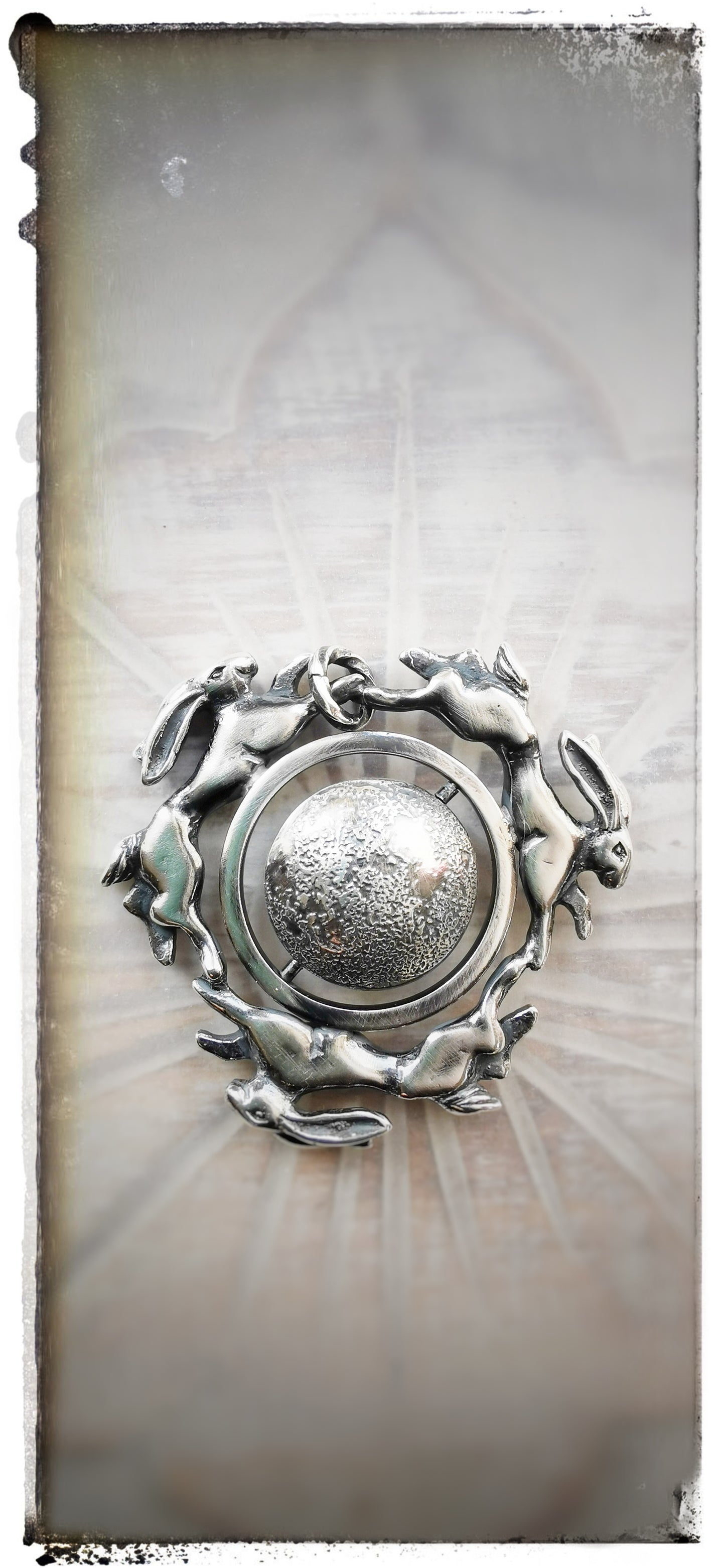 'Moonchasers' triple hare pendant with rotating moon.
