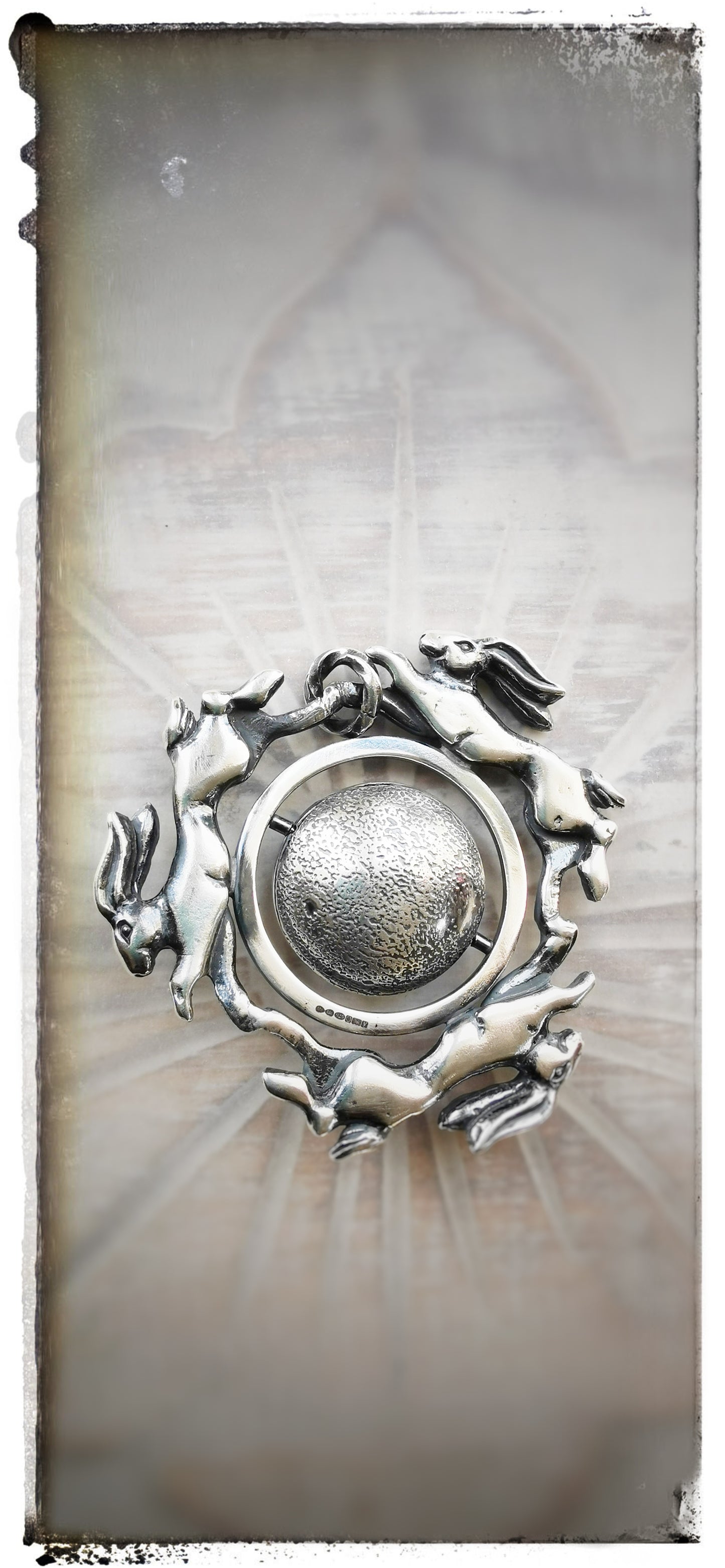 'Moonchasers' triple hare pendant with rotating moon.