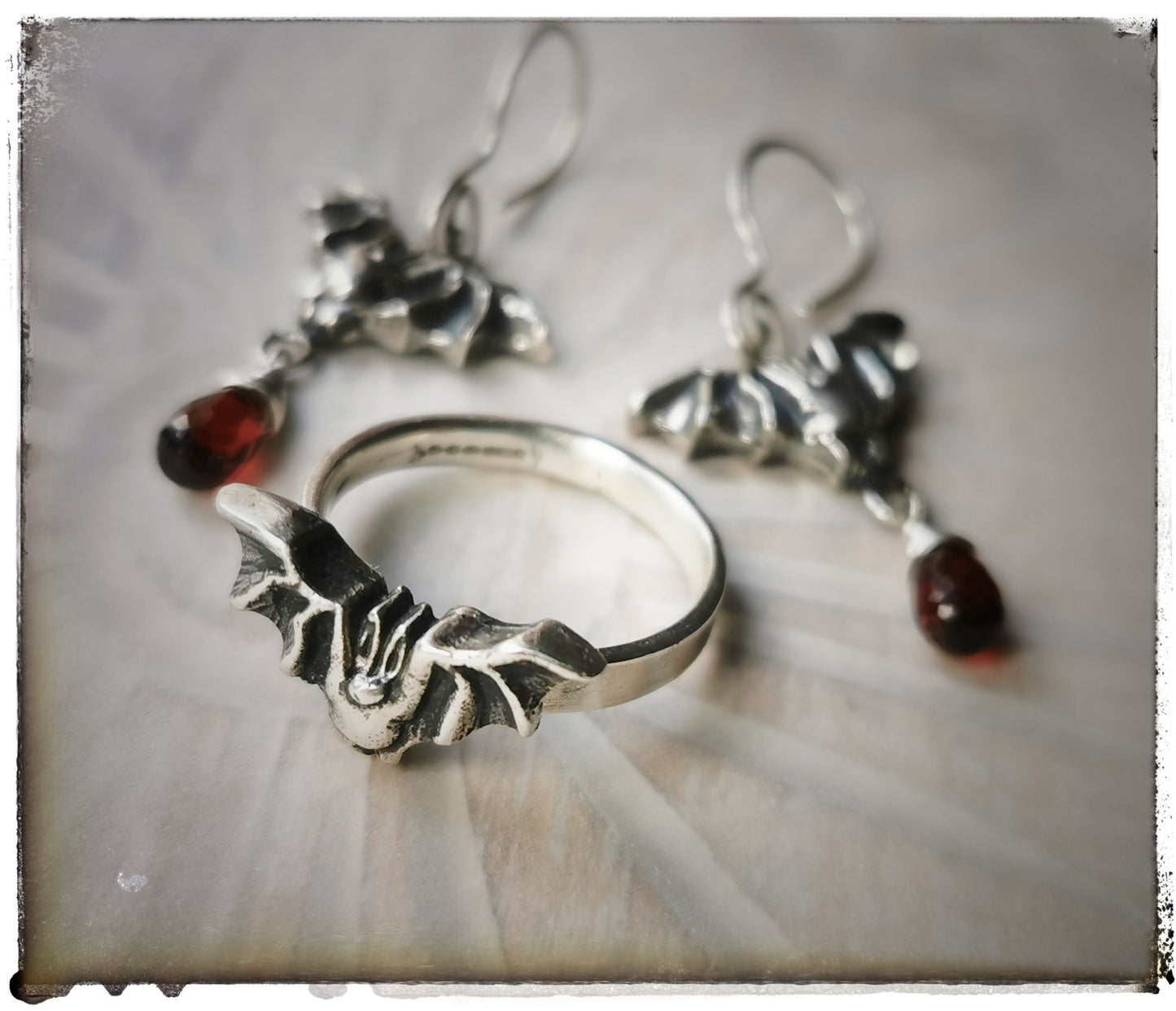 Bat earrings with Garnet drops