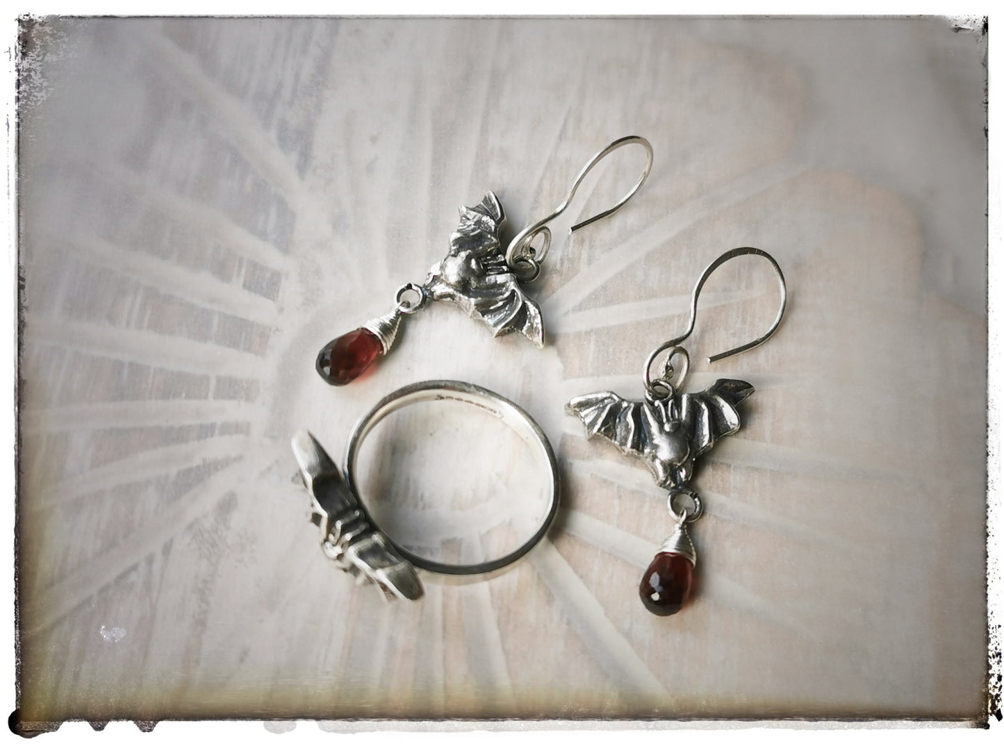 Bat earrings with Garnet drops
