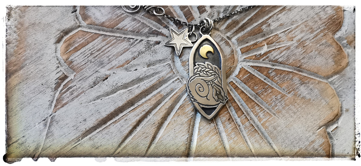 Silver and gold badger pendant