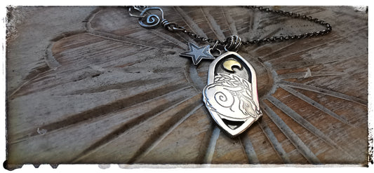 Silver and gold badger pendant